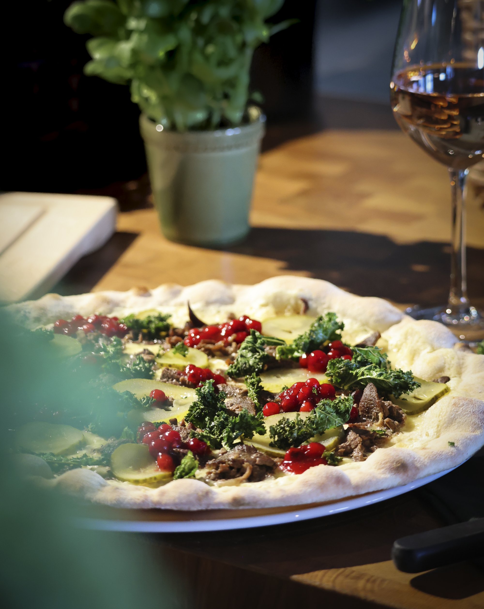 Colorful and tasty Saana pizza at restaurant Saana has sauteed reindeer, lingonberries and crunchy cale with fingersalt as a topping.