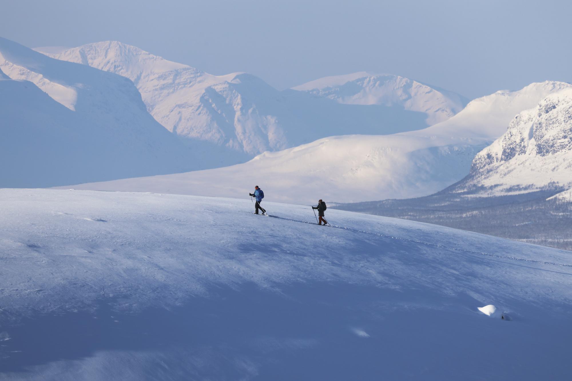 Two skiers in the untouched wilderness in arctic lapland, kilpisjärvi