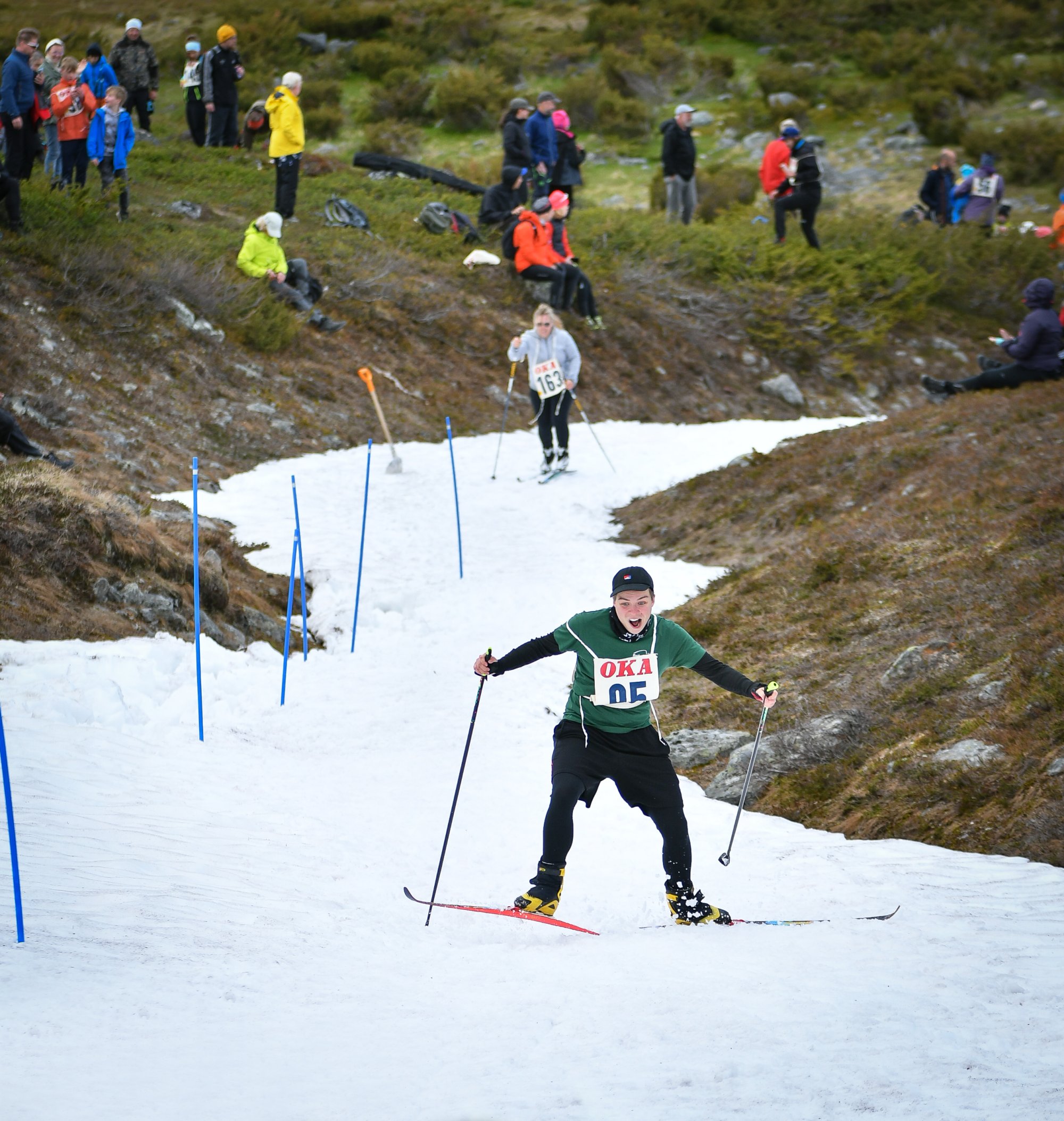 Liisa skiing with a playful expression at the Kilpisjärvi Midsummer Skiing event, just about to lose her balance.