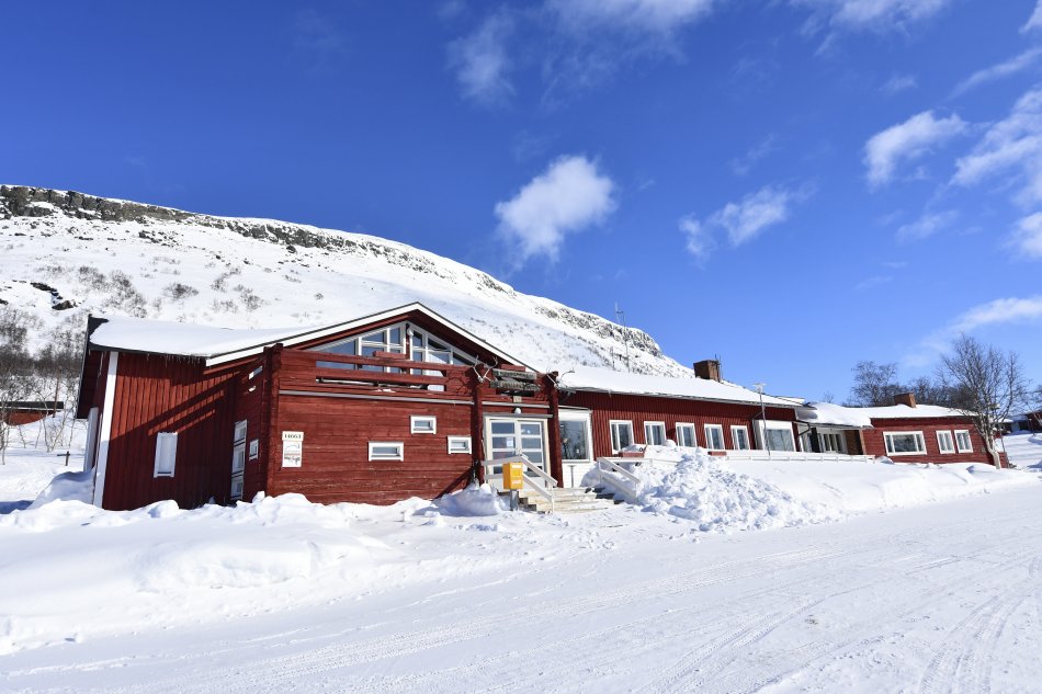 Kilpisjärven Retkeilykeskus in the middle of snow and sunshine, saana fell on the background