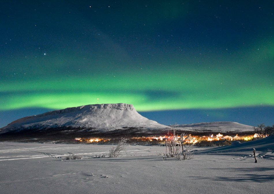 Saana fell under northern lights in  bright moon light.