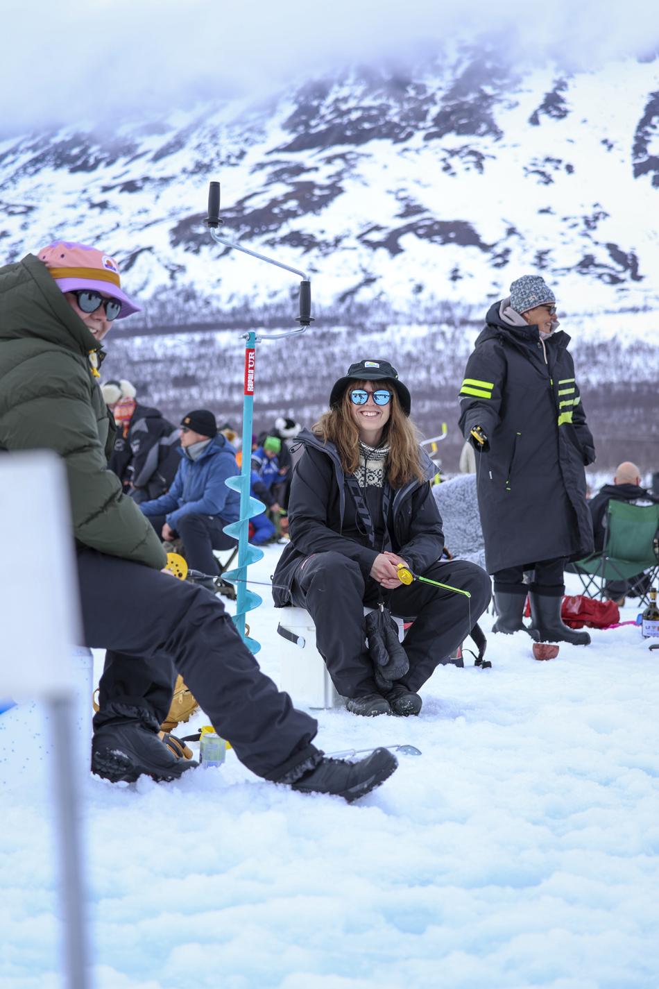 Happy people on the frozen lake Kilpisjärvi entering the vain kaksi kalaa ice fishing competition